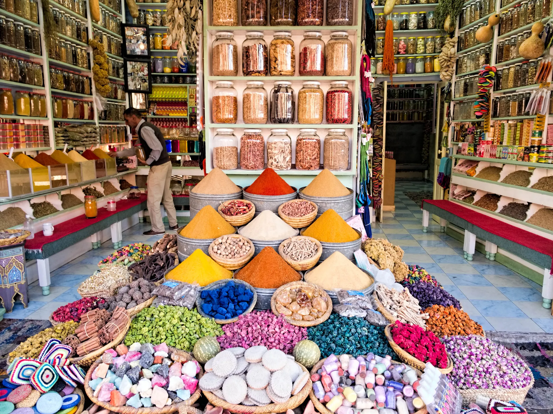 A spice stall in a Moroccan souk — coloured pyramids of cumin, paprika and turmeric, a classic excursion from the Fairmont