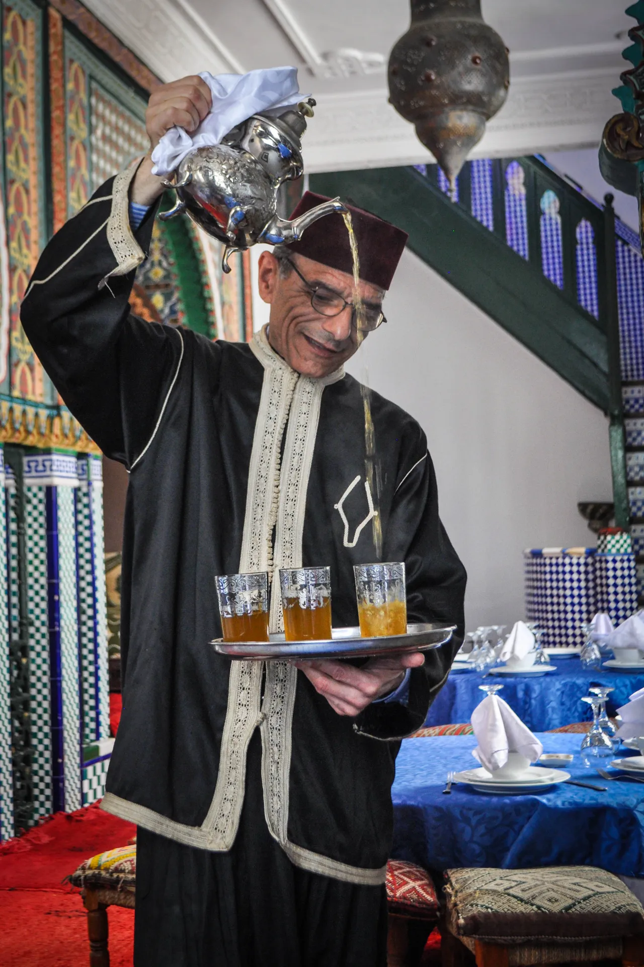 Traditional Moroccan mint tea poured into a tinted glass — a ritual the Fairmont's fine-dining restaurants build into the experience